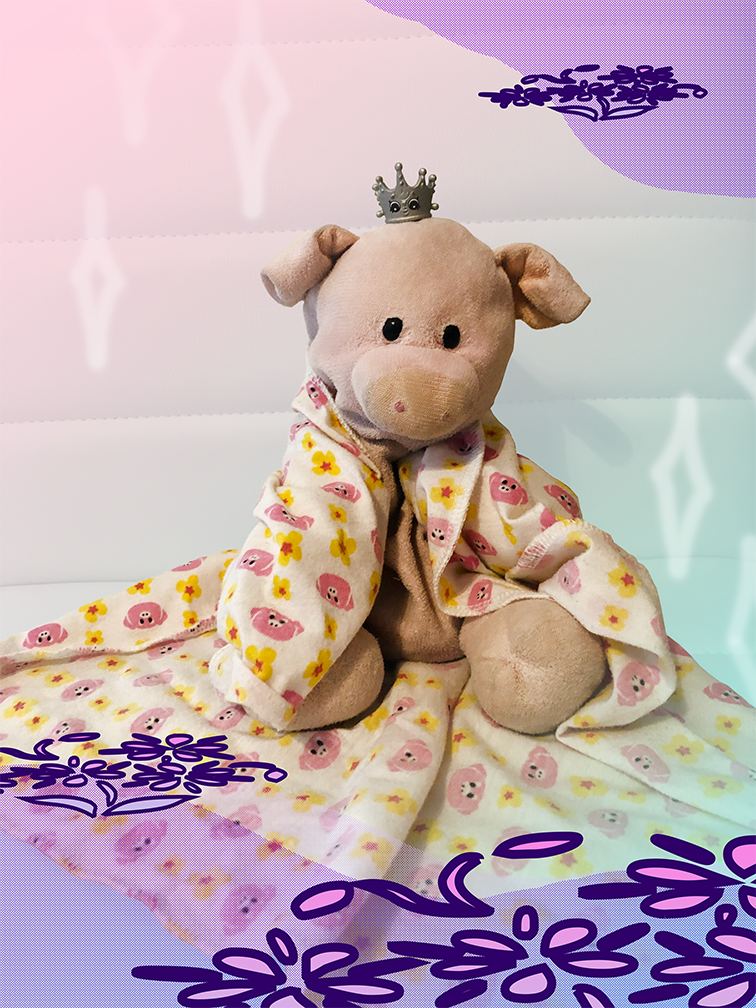 Piggy sitting with a blanket with a pig pattern draped over his shoulders and a Shopkin crown on his head. There are some sparkles and flowers drawn around him.